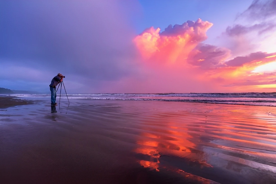Photographer clicking photos of beautiful sunset at beach