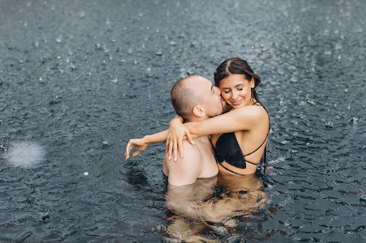 Couple enjoying Monsoon in pool reosrt in Goa