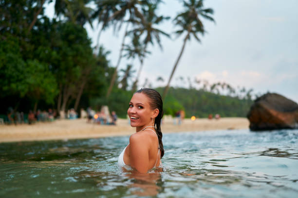 Happy woman enjoying time on Morjim beach 